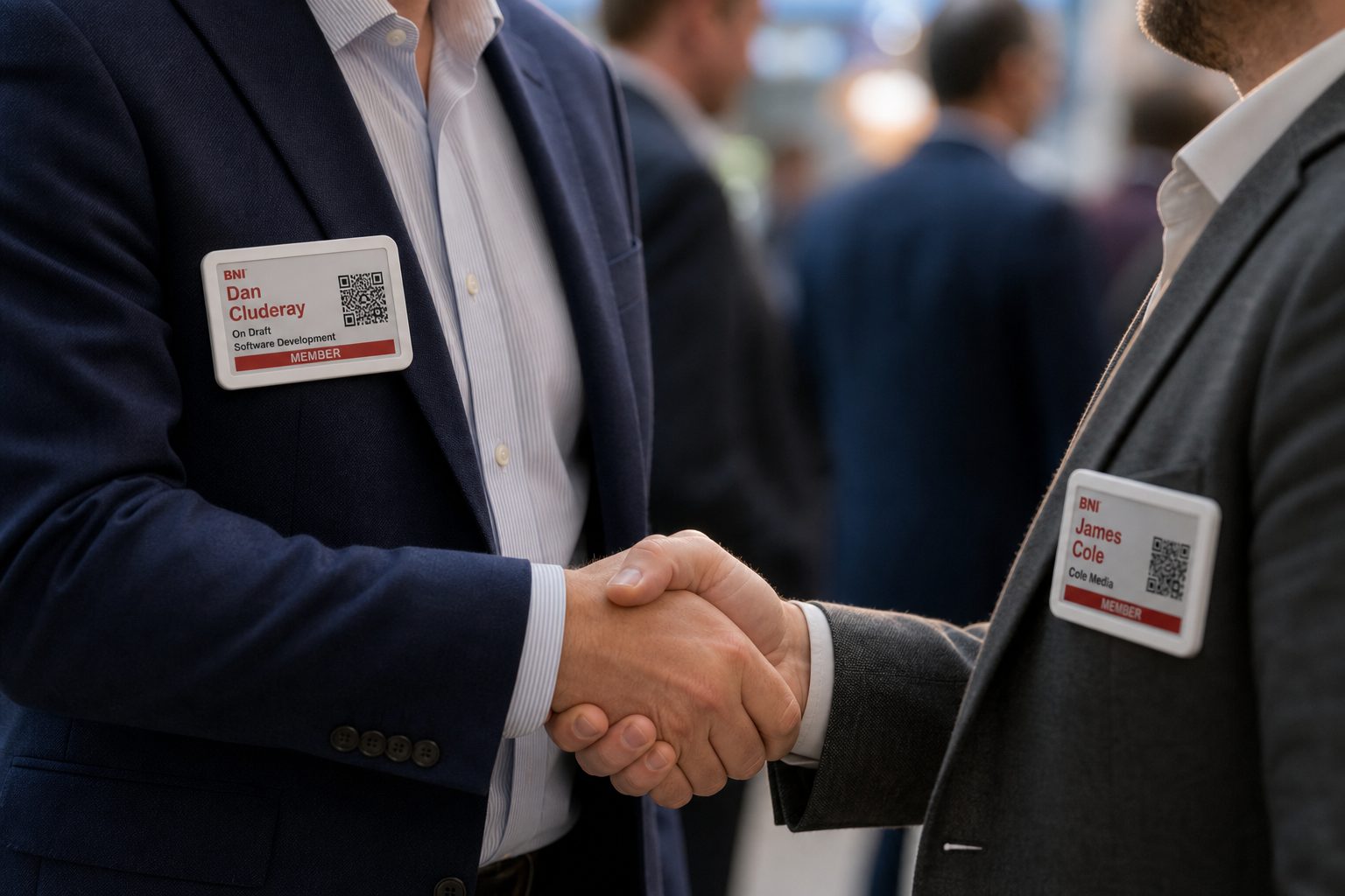 Handshake with e-ink member badges on both lapels
